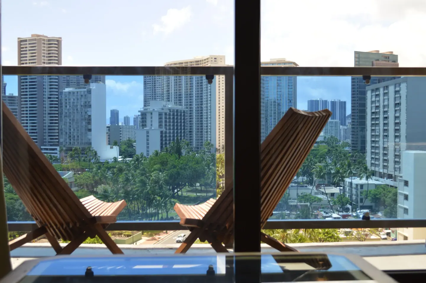 Lanai chairs and skyline view from a Premium Kalakaua Haus room at Hotel La Croix.