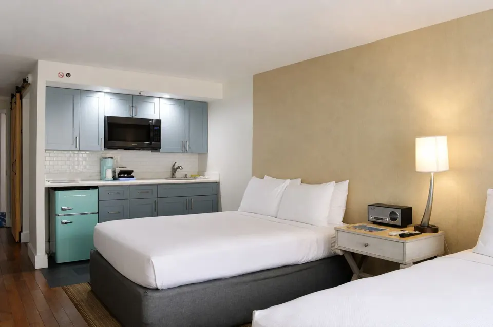Premium Kalakaua Haus Kitchenette room with bed, nightstand and kitchenette at Hotel La Croix.