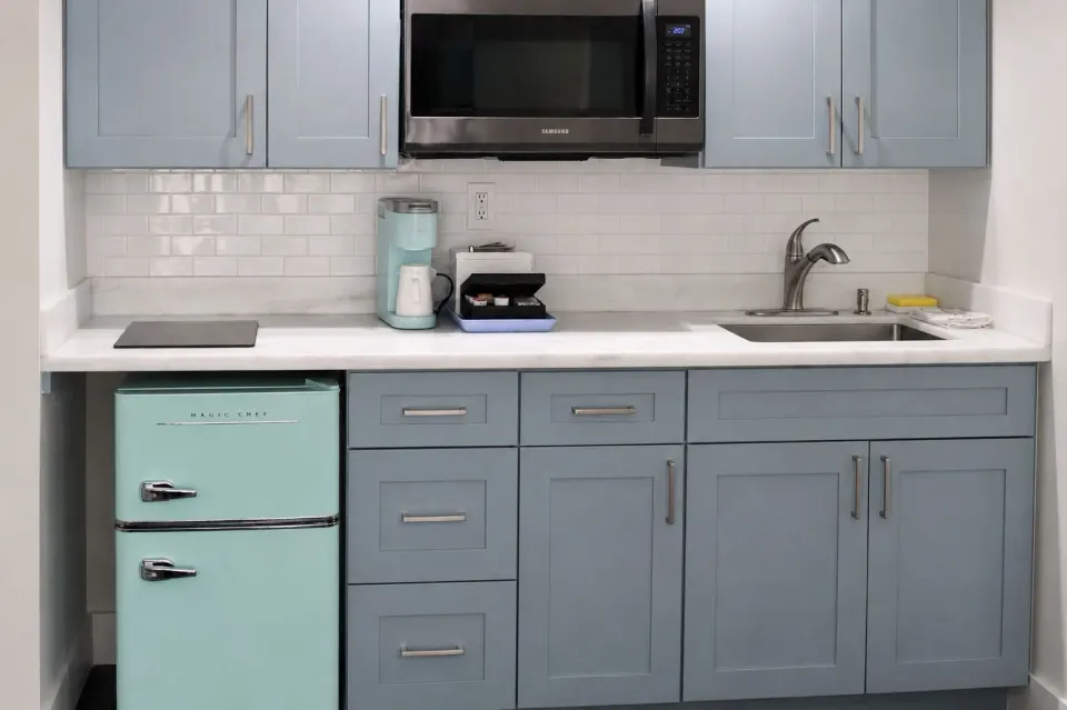 Premium Kalakaua Haus Kitchenette cabinets, sink, microwave and mini fridge at Hotel La Croix.