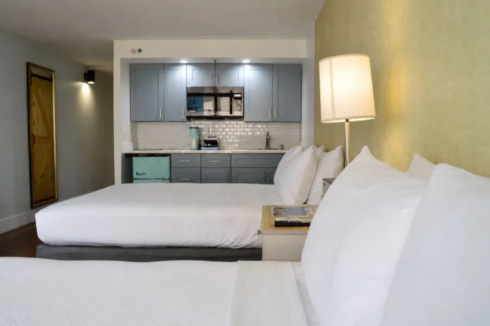Premium Kalakaua Haus Kitchenette room with two beds and kitchen area at Hotel La Croix.