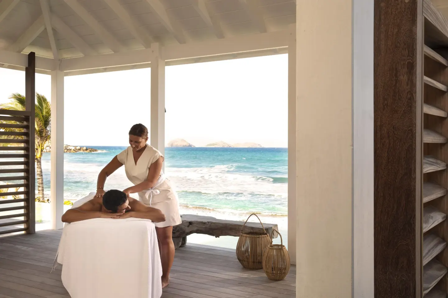 Massage treatment on an open-air oceanfront terrace at Hotel Manapany.