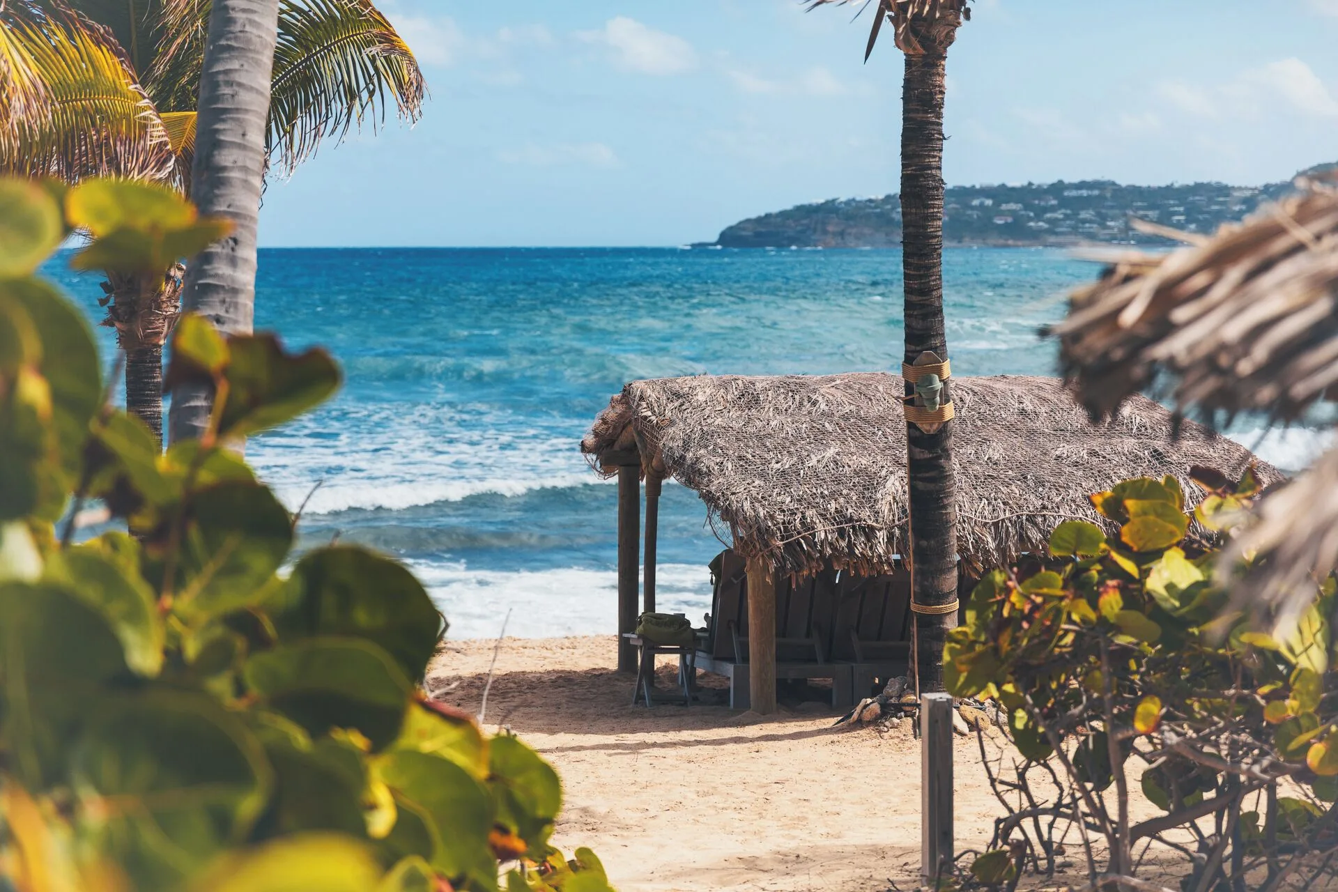 Thatched beach cabana facing the turquoise sea at Hotel Manapany.