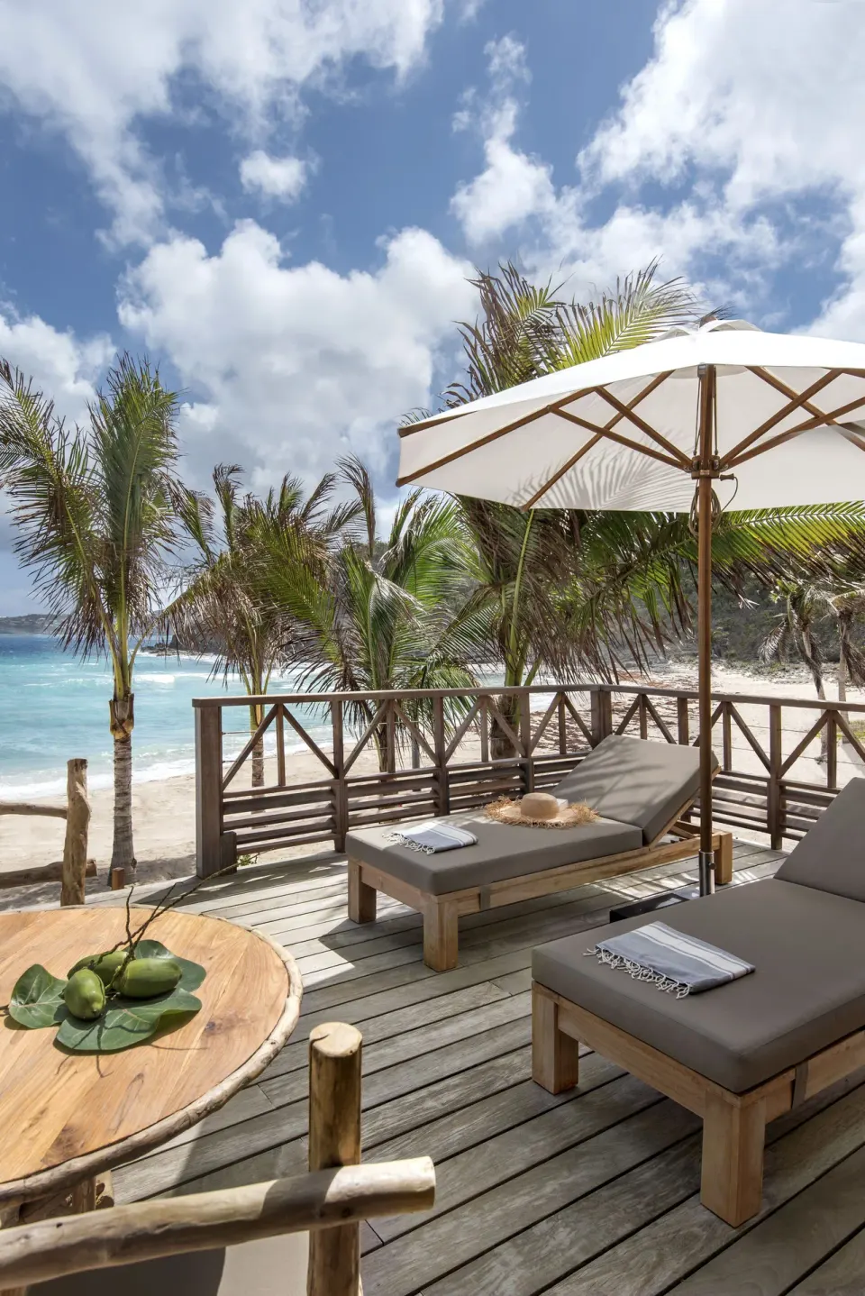 Junior Suite Beach View private deck with loungers and umbrella at Hotel Manapany.