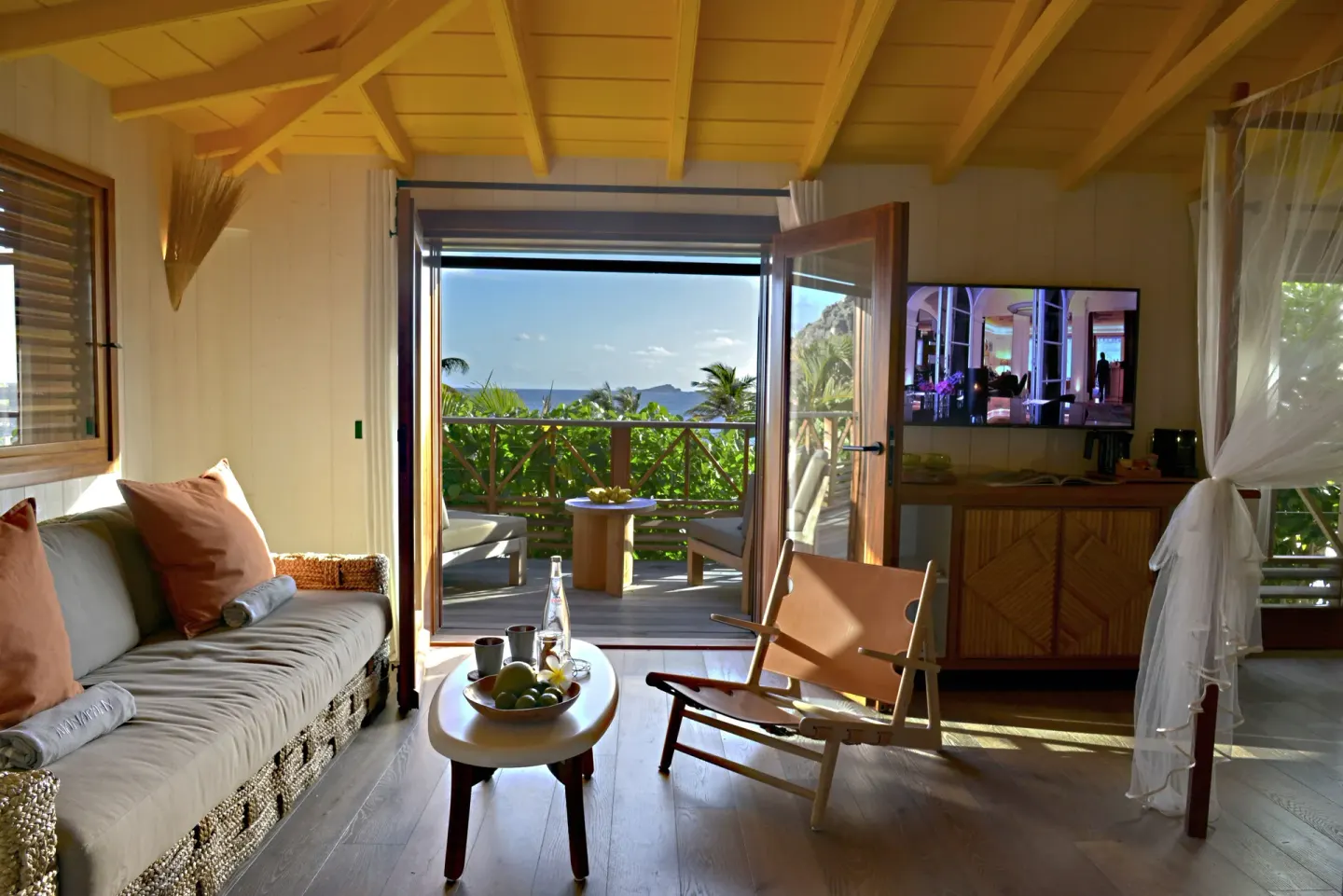 Junior Suite Beach View lounge with open terrace doors at Hotel Manapany.