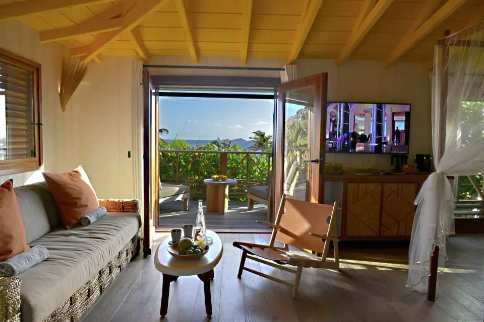 Junior Suite Beach View lounge with open terrace doors at Hotel Manapany.