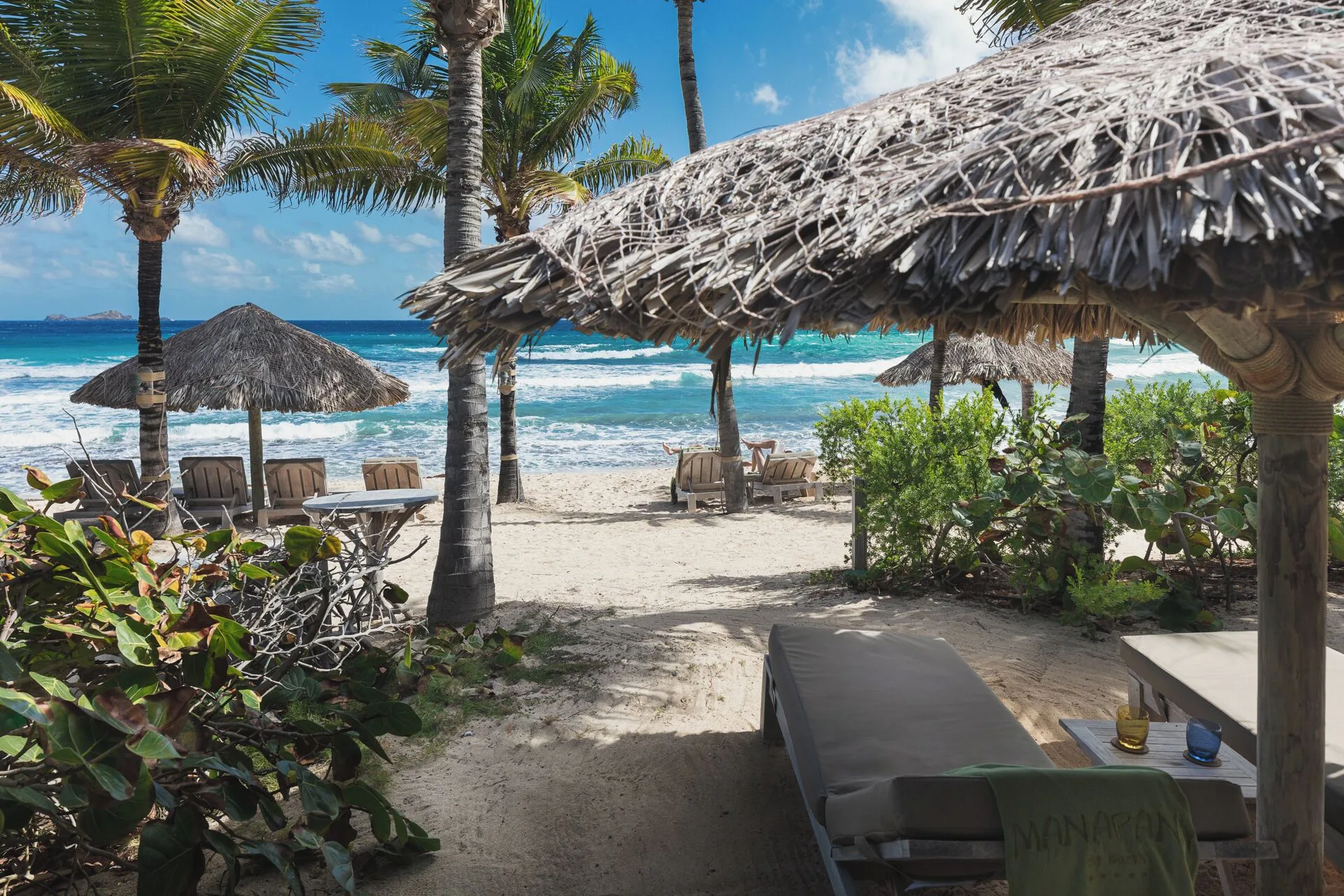 Junior Suite Beach View beachfront terrace with thatched shade and loungers at Hotel Manapany.
