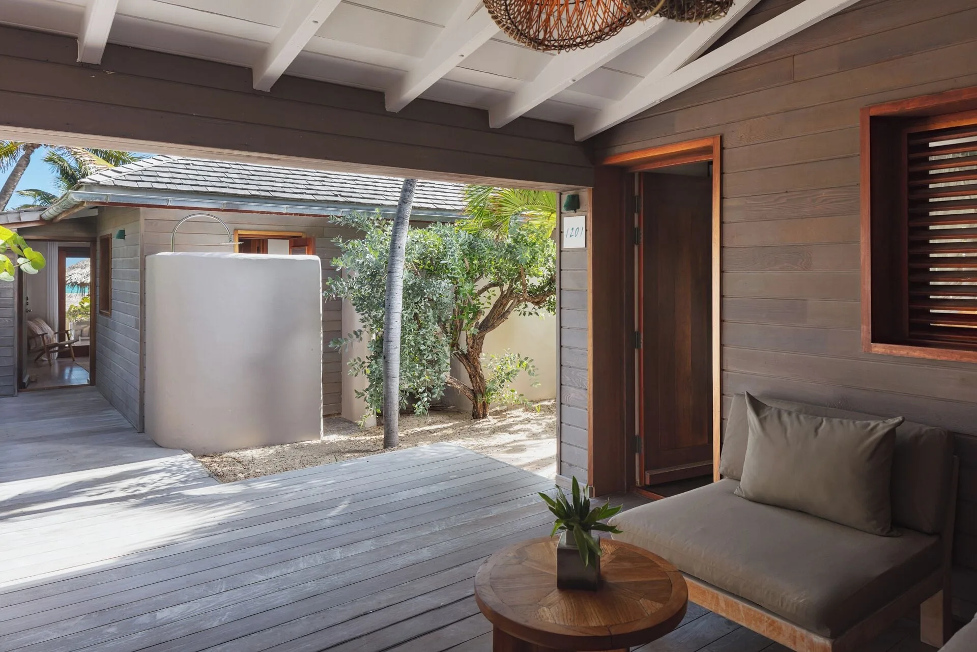 Junior Suite Beach View shaded terrace with lounge chair and garden path at Hotel Manapany.