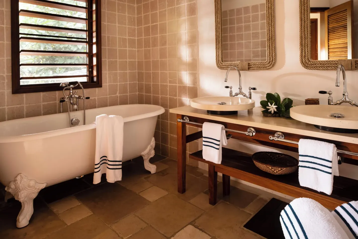Junior Suite Ocean View bathroom with clawfoot tub and double sinks at Hotel Manapany.