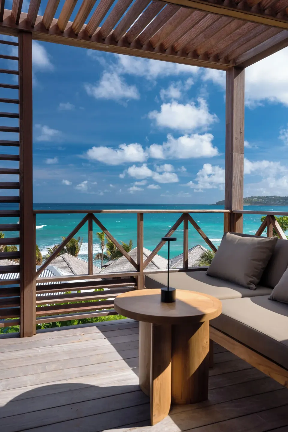 Ocean View room terrace at Hotel Manapany with cushioned seating and a sweeping sea view.