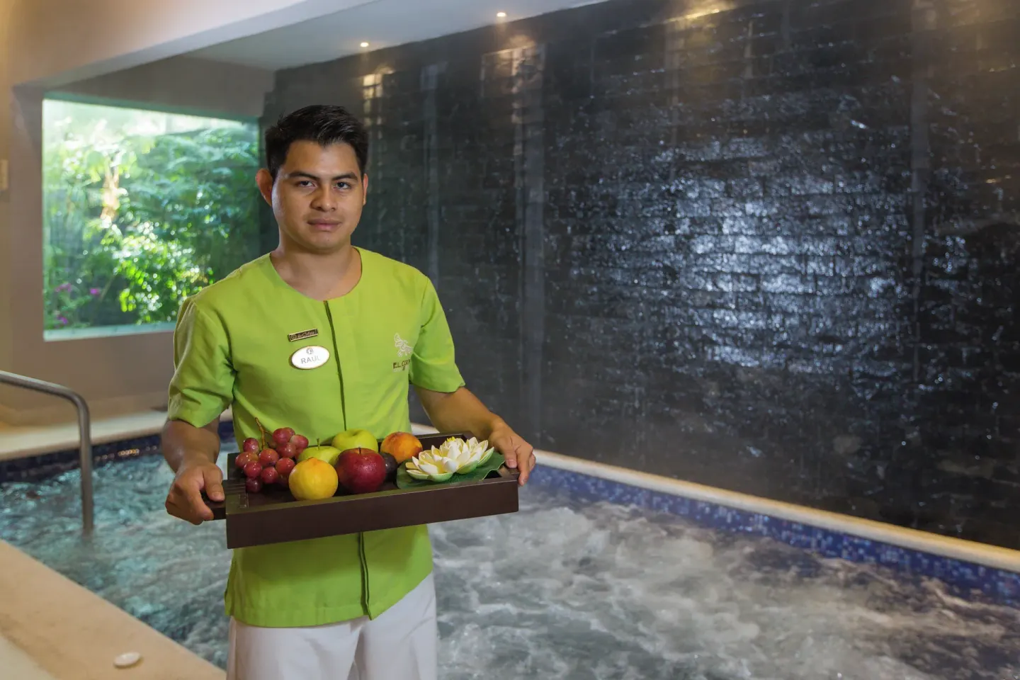 Spa attendant presents a fruit tray by a whirlpool at Hotel Marina El Cid Spa & Beach Resort.