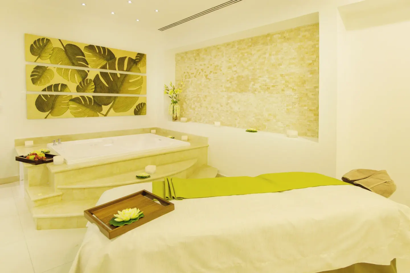 Spa treatment bed and soaking tub at Hotel Marina El Cid Spa & Beach Resort.