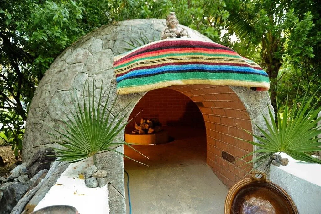 Temazcal-style stone sauna entrance at Hotel Marina El Cid Spa & Beach Resort.