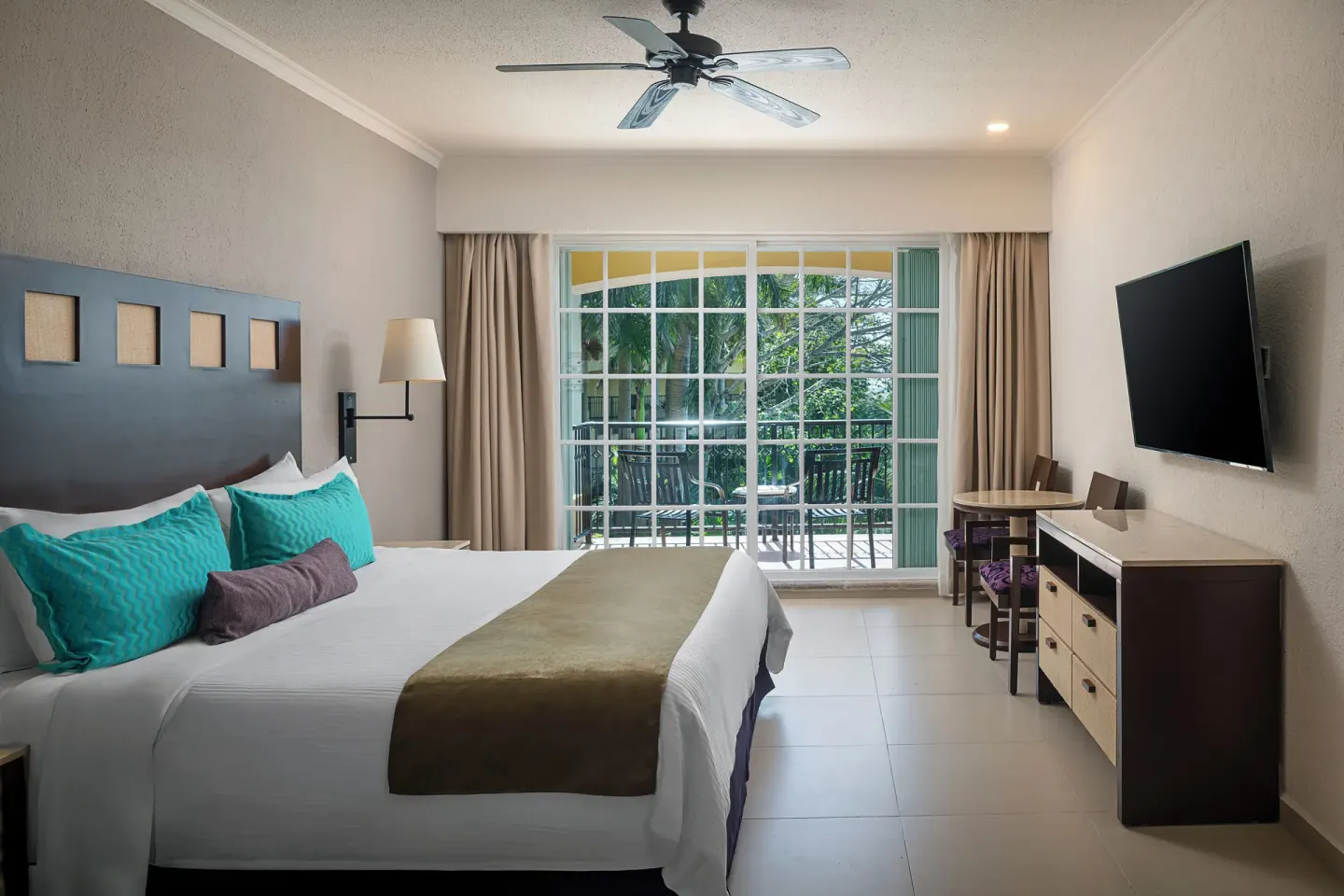 One Bedroom Suite with king bed and balcony at Hotel Marina El Cid Spa & Beach Resort.