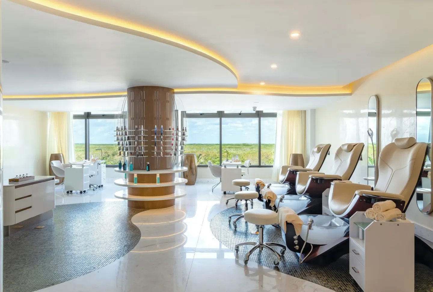 Nail salon treatment chairs with large windows at Hotel Mousai Cancun.