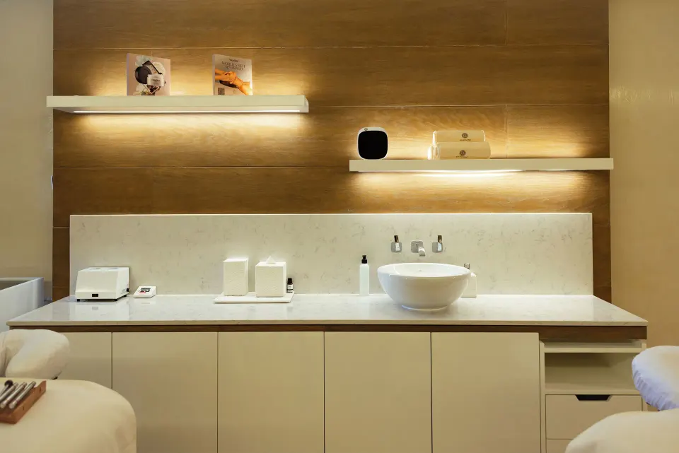 Spa treatment room counter with sink and warm lighting at Hotel Mousai Cancun.
