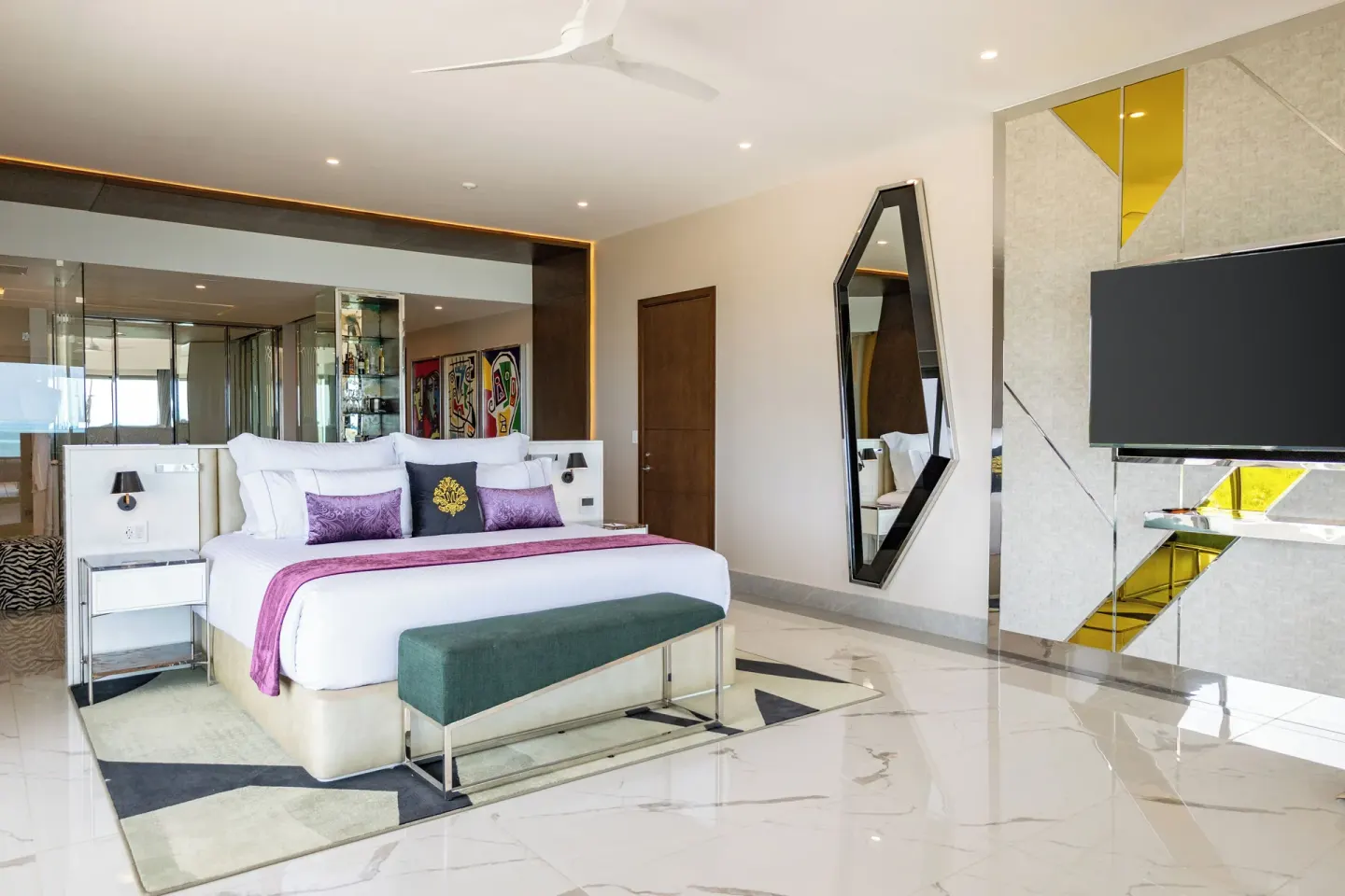Corner Suite Ocean Front bedroom with king bed and TV at Hotel Mousai Cancun.