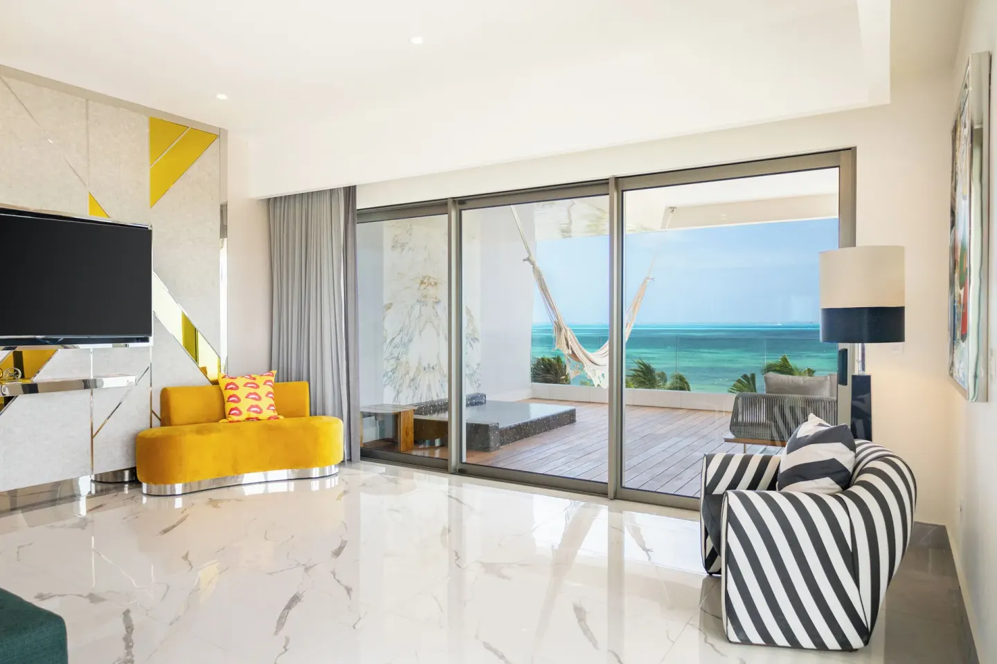 Corner Suite Ocean Front sitting area and balcony doors at Hotel Mousai Cancun.