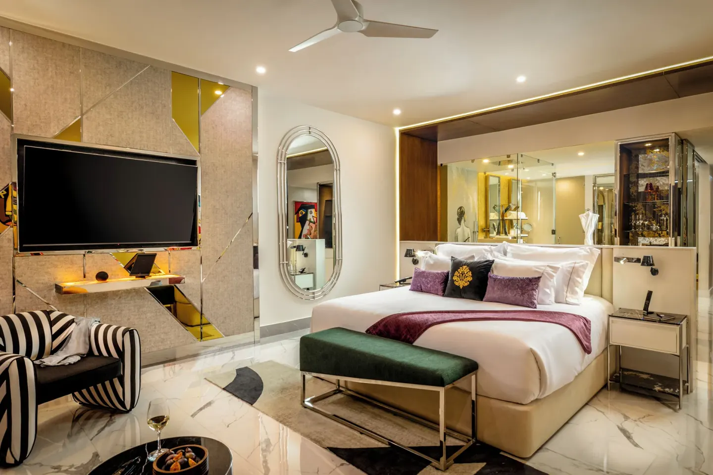 Suite ocean front king bed with TV wall and glass bath area at Hotel Mousai Cancun.
