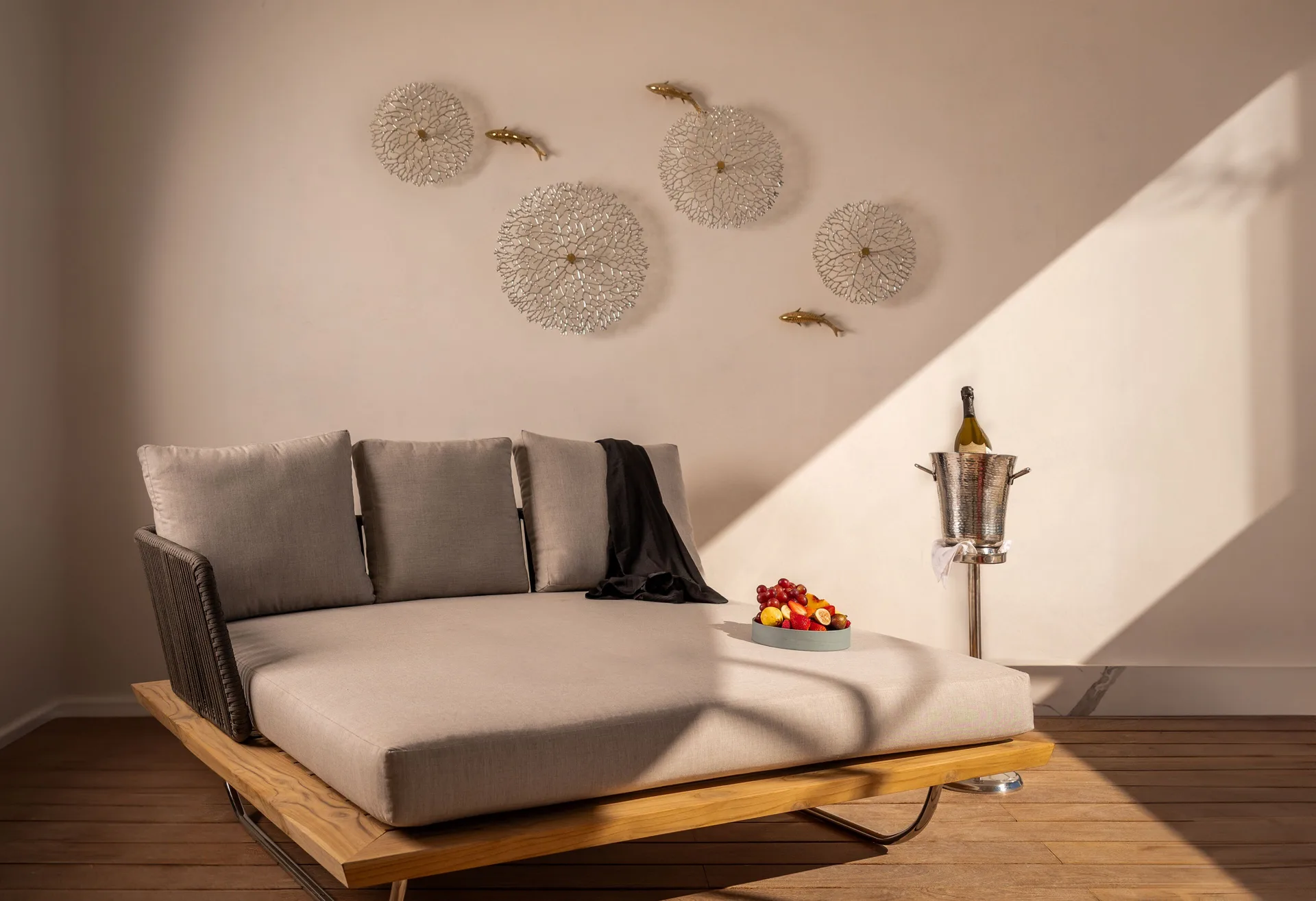 Ocean front suite terrace daybed with fruit and wine at Hotel Mousai Cancun.