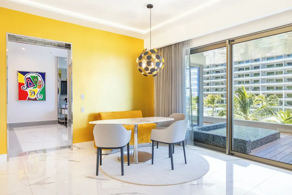 Dining nook by balcony doors in a Two Bedroom Master Suite at Hotel Mousai Cancun.