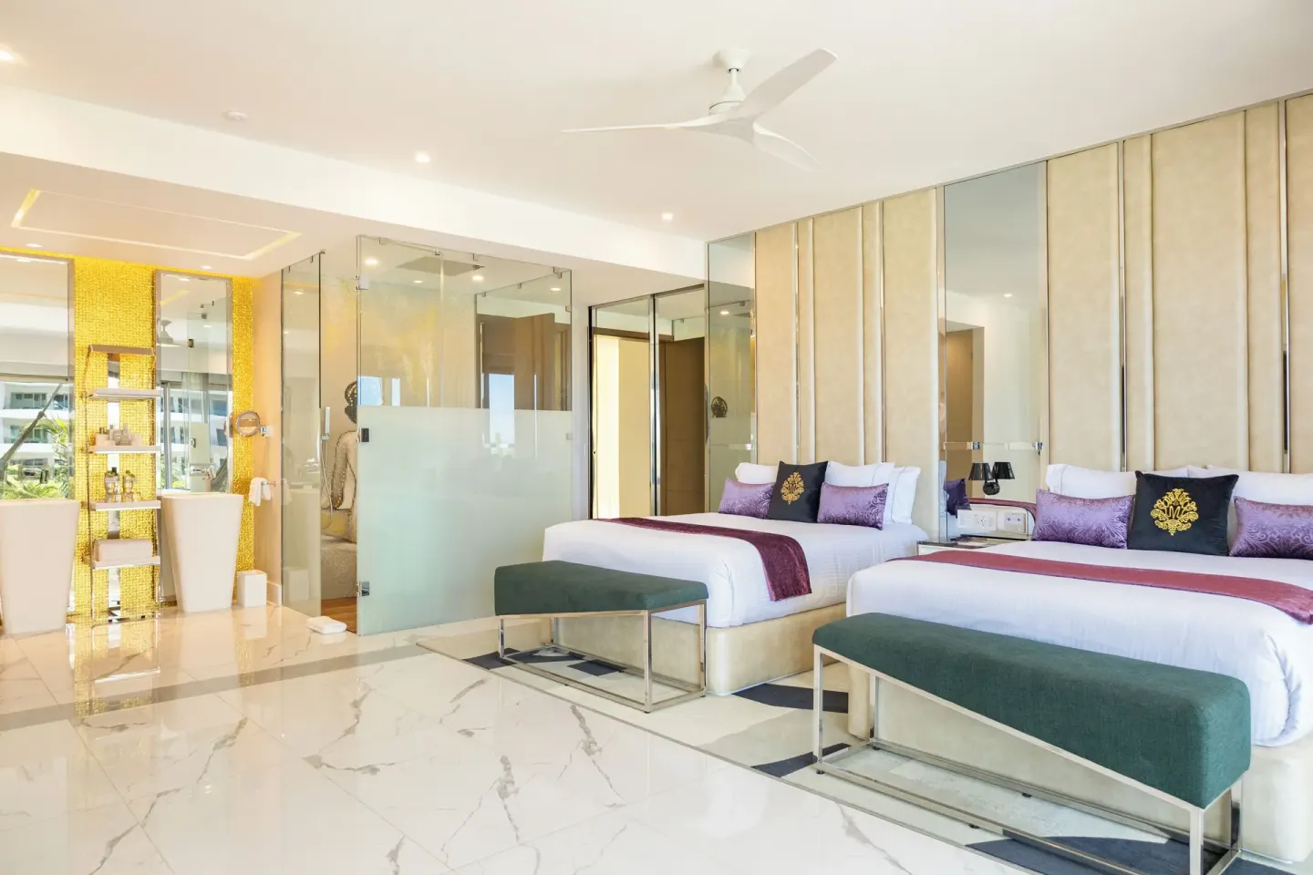 Two beds and open bath area in a Two Bedroom Master Suite at Hotel Mousai Cancun.