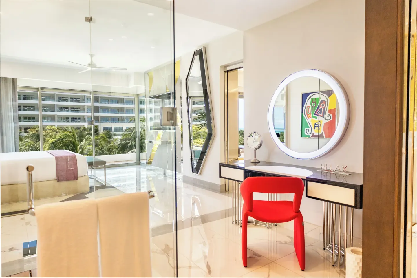 Vanity and glass-walled bedroom in a Two Bedroom Master Suite at Hotel Mousai Cancun.