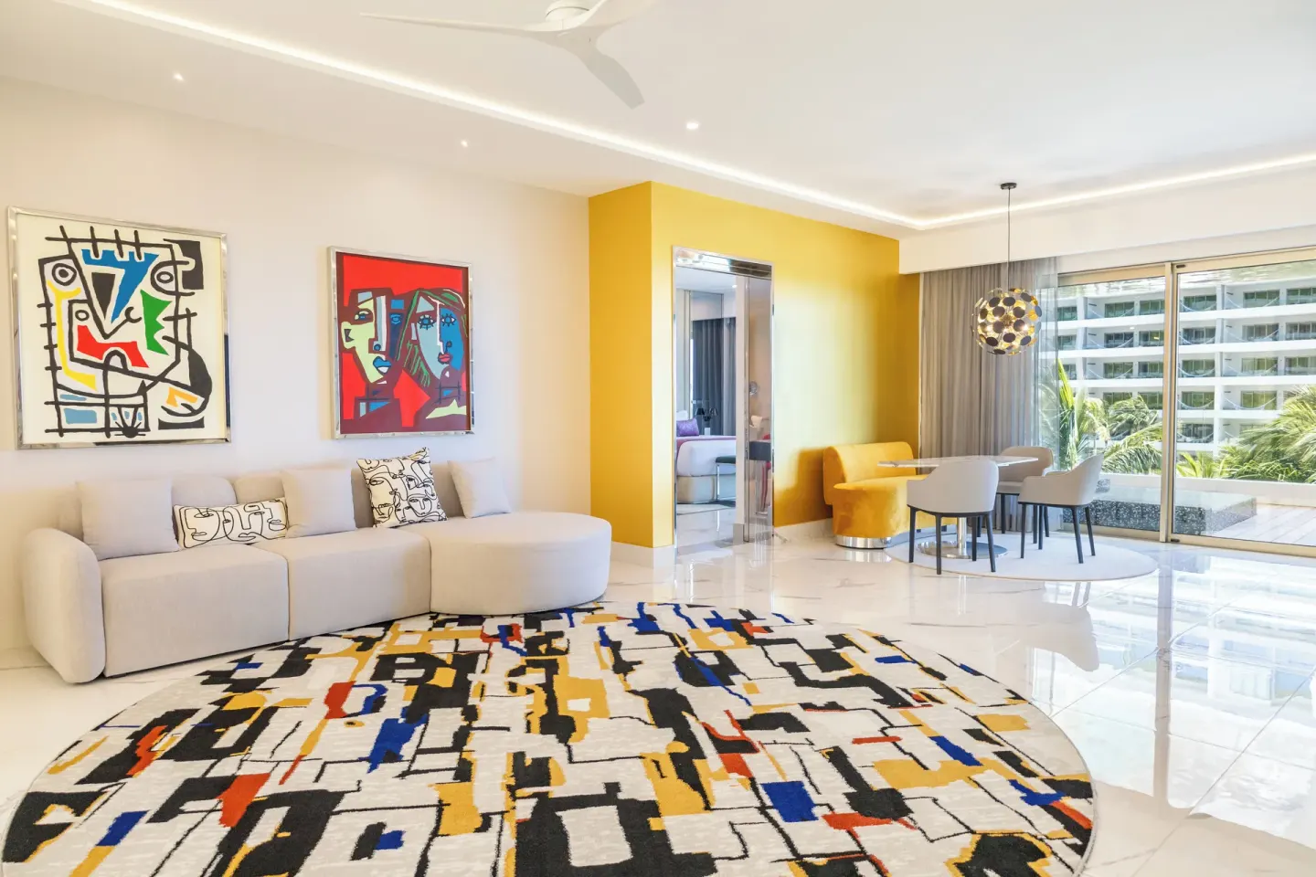 Ultra Two Bedroom Master Suite living room with sofa and dining area at Hotel Mousai Cancun.