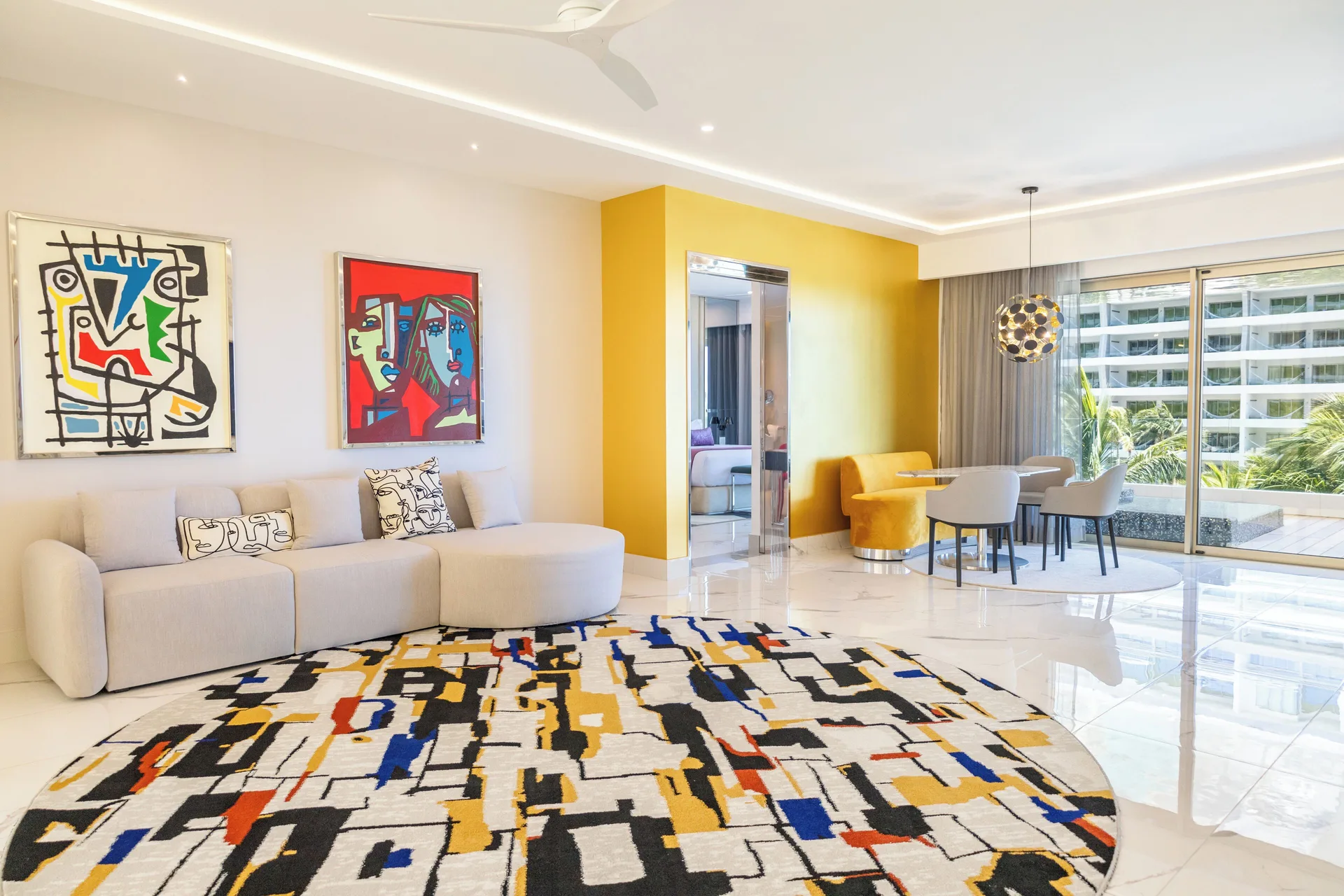 Ultra Two Bedroom Master Suite living room with sofa and dining area at Hotel Mousai Cancun.