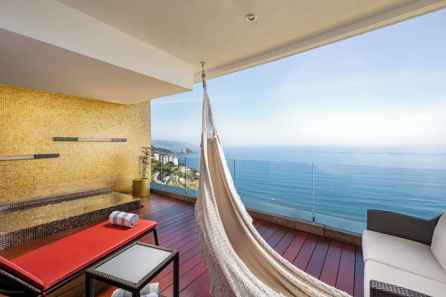 Balcony hammock with red lounger and ocean view at Hotel Mousai Puerto Vallarta.