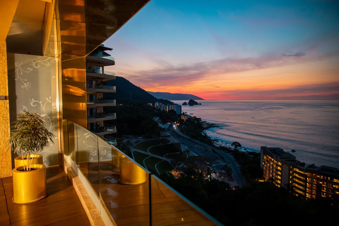 Balcony view of the coastline at sunset from Hotel Mousai Puerto Vallarta.