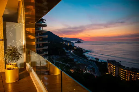 Balcony view of the coastline at sunset from Hotel Mousai Puerto Vallarta.