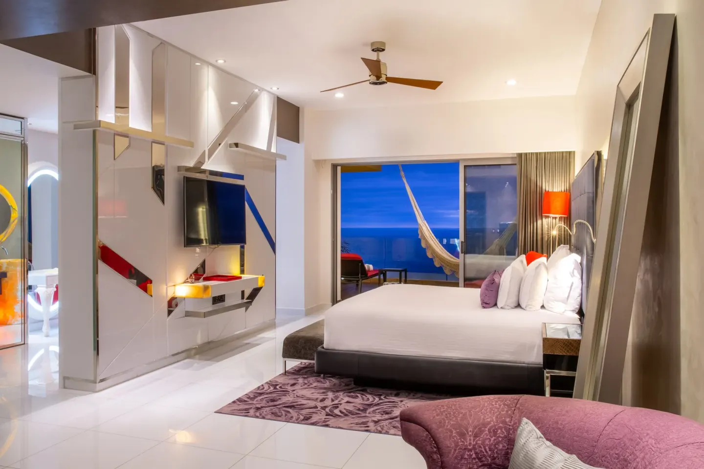 King bed guest room with balcony hammock and ocean view at Hotel Mousai Puerto Vallarta.