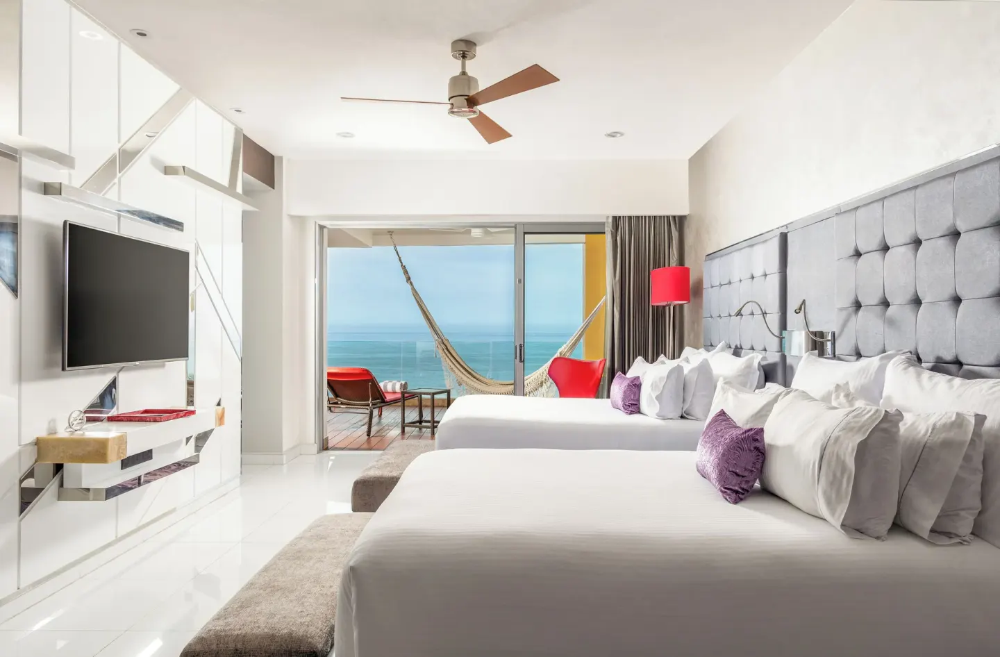 Two bed guest room with ocean-view balcony and hammock at Hotel Mousai Puerto Vallarta.