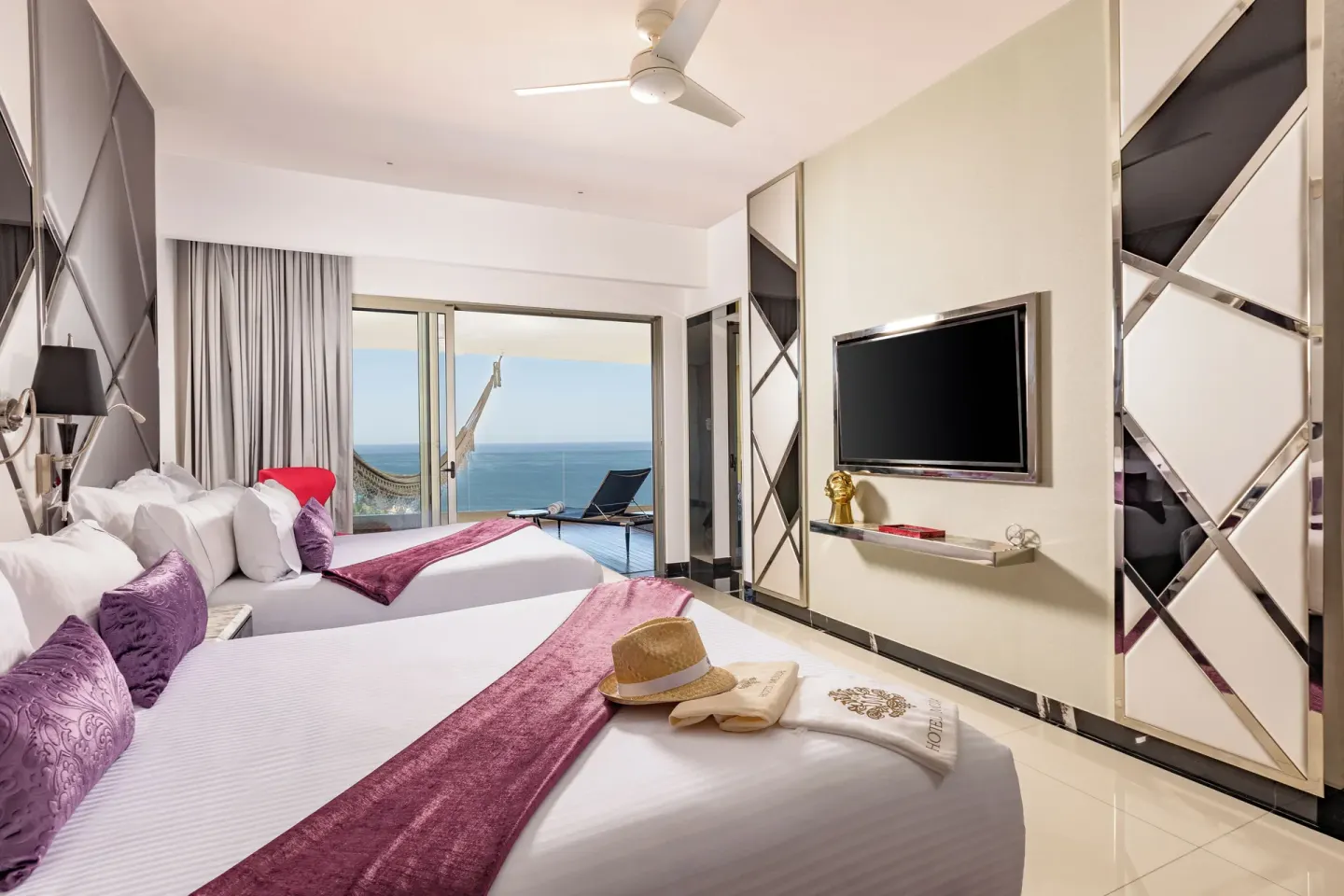 Two bed guest room with balcony hammock and ocean view at Hotel Mousai Puerto Vallarta.