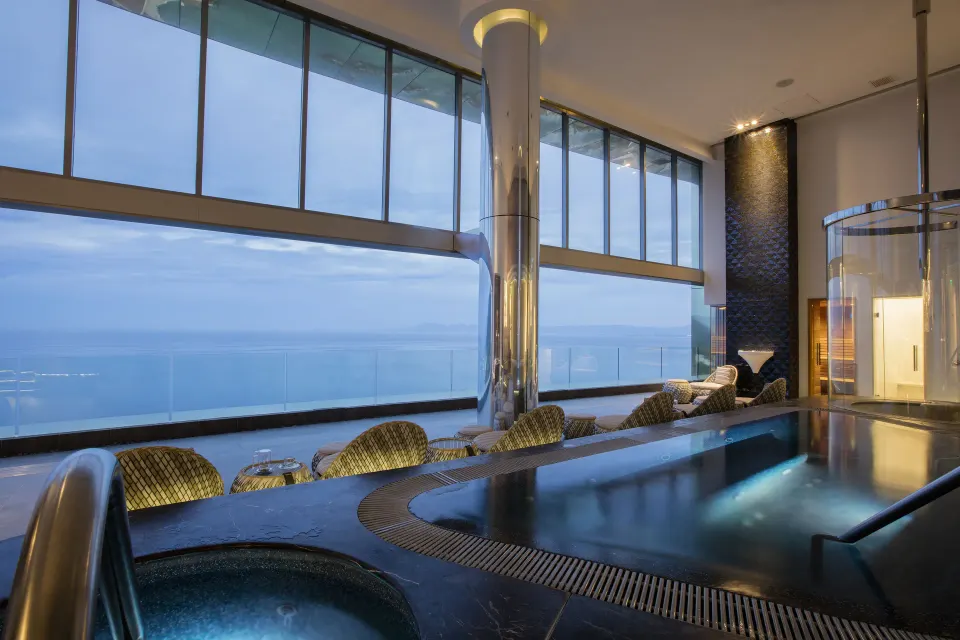 Indoor pool and hot tub overlooking the ocean at Hotel Mousai Puerto Vallarta.