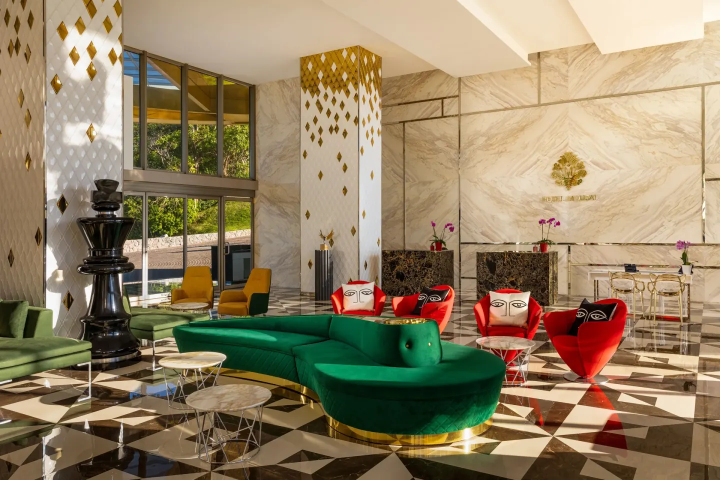Colorful lobby seating and marble walls at Hotel Mousai Puerto Vallarta.