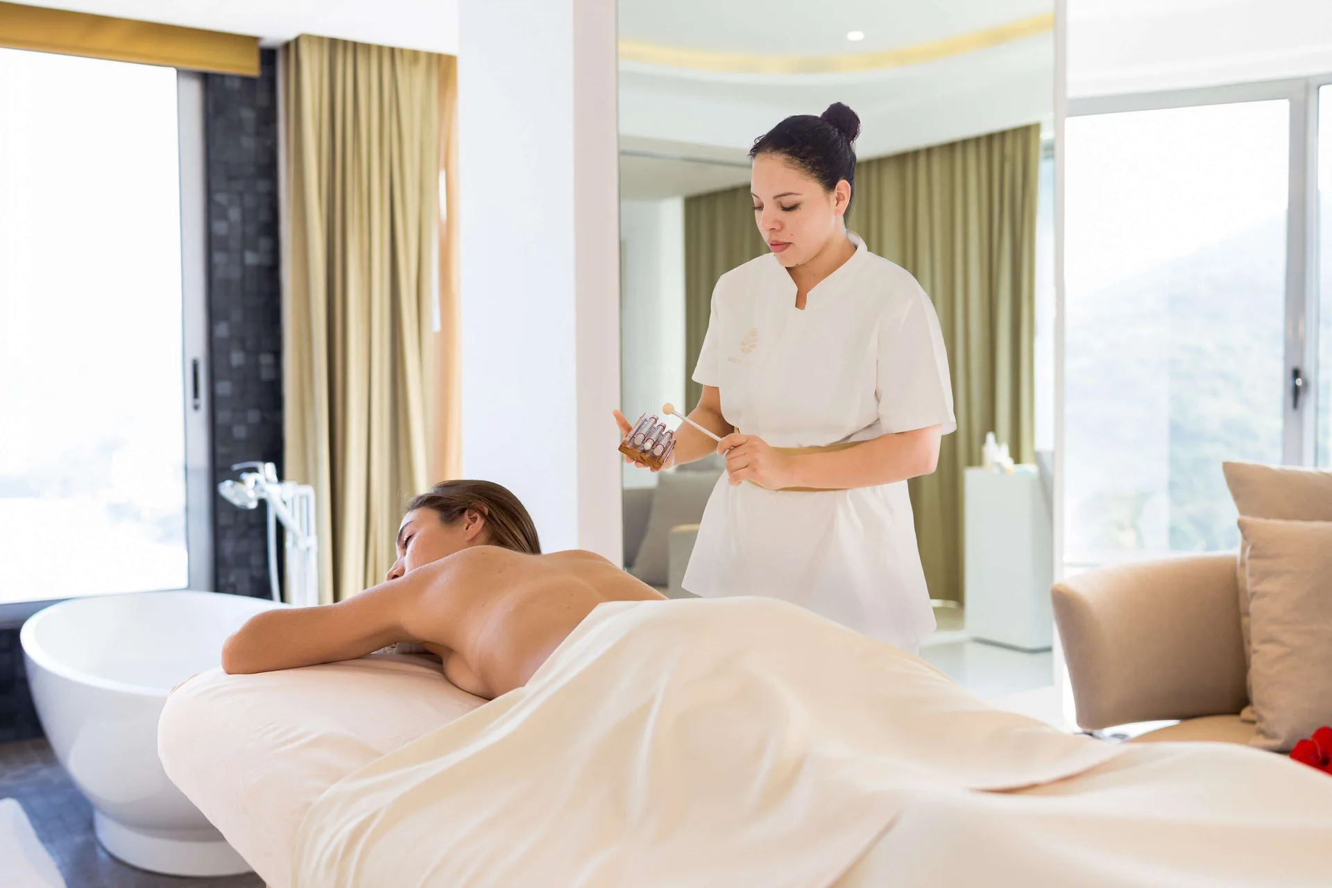 Massage treatment in a bright room at Hotel Mousai Puerto Vallarta.