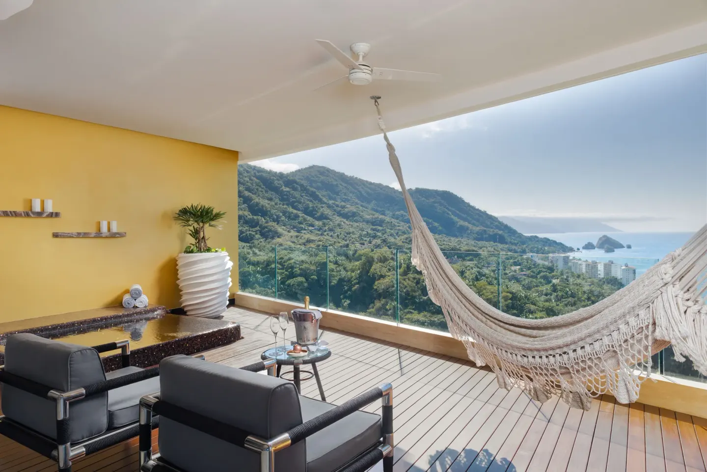 Ocean-view terrace with hammock and lounge chairs at Hotel Mousai Puerto Vallarta.