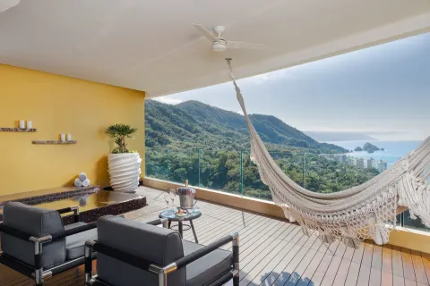 Ocean-view terrace with hammock and lounge chairs at Hotel Mousai Puerto Vallarta.