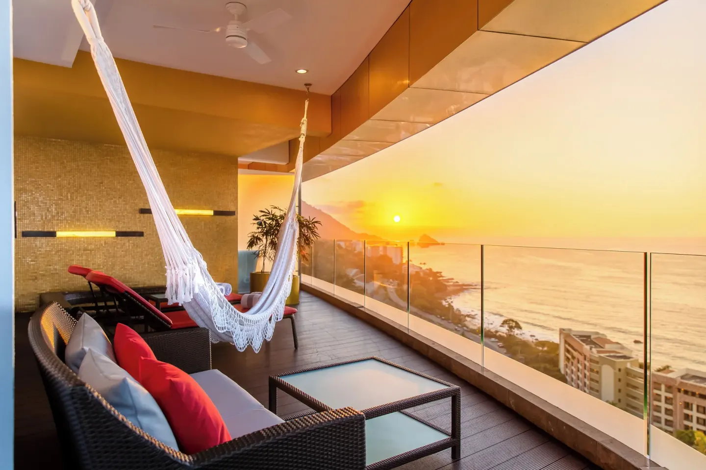 Sunset terrace with hammock and outdoor seating at Hotel Mousai Puerto Vallarta.