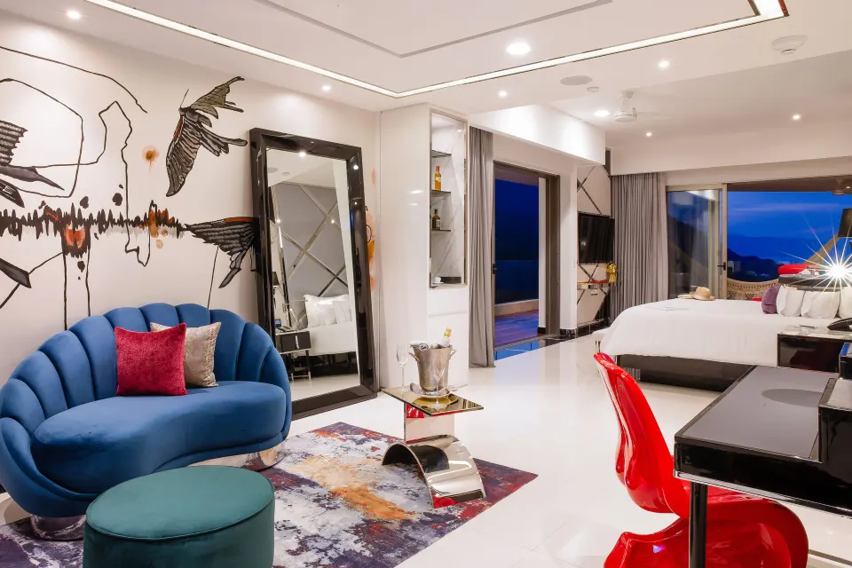 Corner Suite sitting area and king bed at Hotel Mousai Puerto Vallarta.