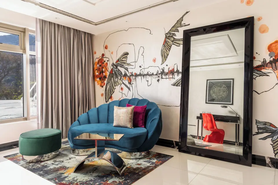 Corner Suite sitting area with blue sofa at Hotel Mousai Puerto Vallarta.