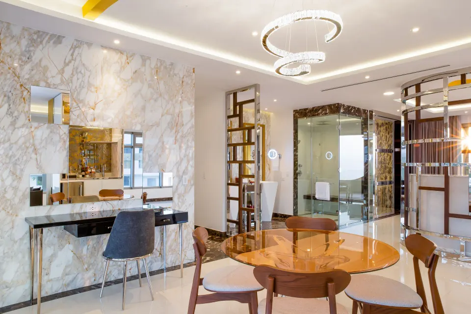 Master Suite dining table, vanity, and glass shower area at Hotel Mousai Puerto Vallarta.
