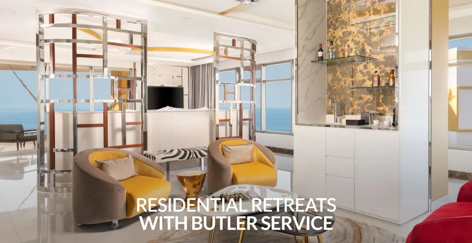 Master Suite sitting area with lounge chairs, bar shelves, and ocean windows at Hotel Mousai Puerto Vallarta.