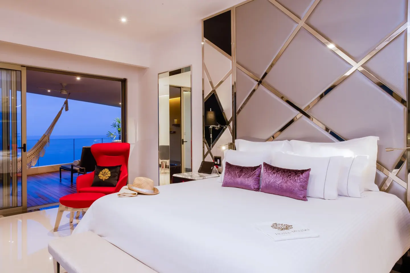 Ultra Corner room with king bed and ocean-view balcony at Hotel Mousai Puerto Vallarta.