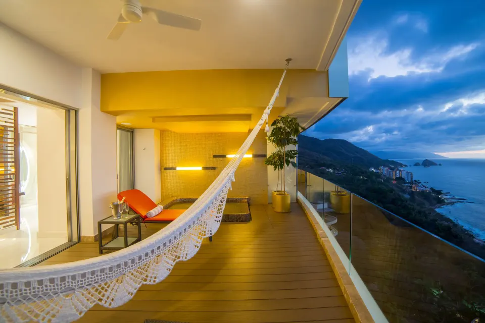 Ultra Two Bedroom Suite balcony with hammock and coastline view at Hotel Mousai Puerto Vallarta.