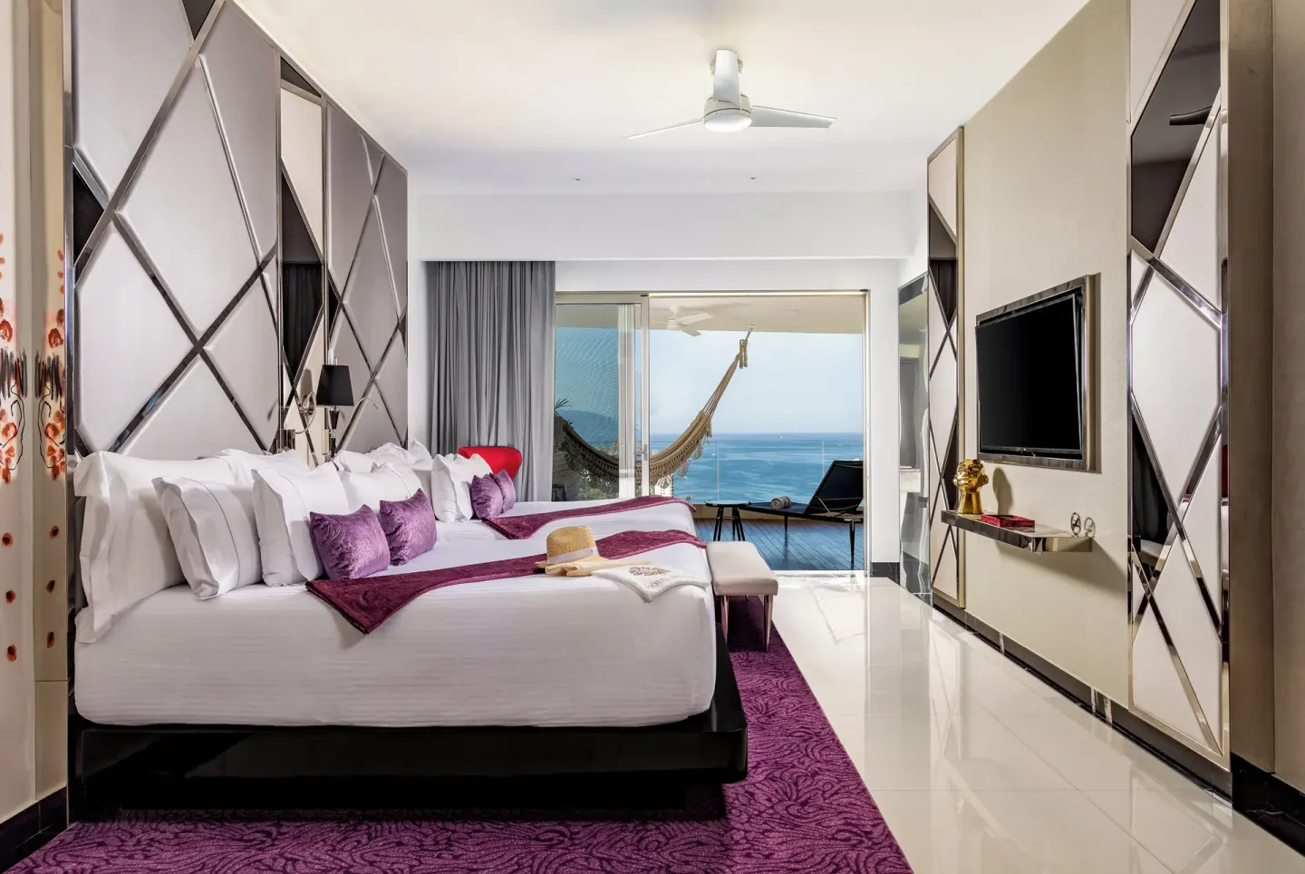 Ultra Two Bedroom Suite bedroom with ocean-facing balcony at Hotel Mousai Puerto Vallarta.