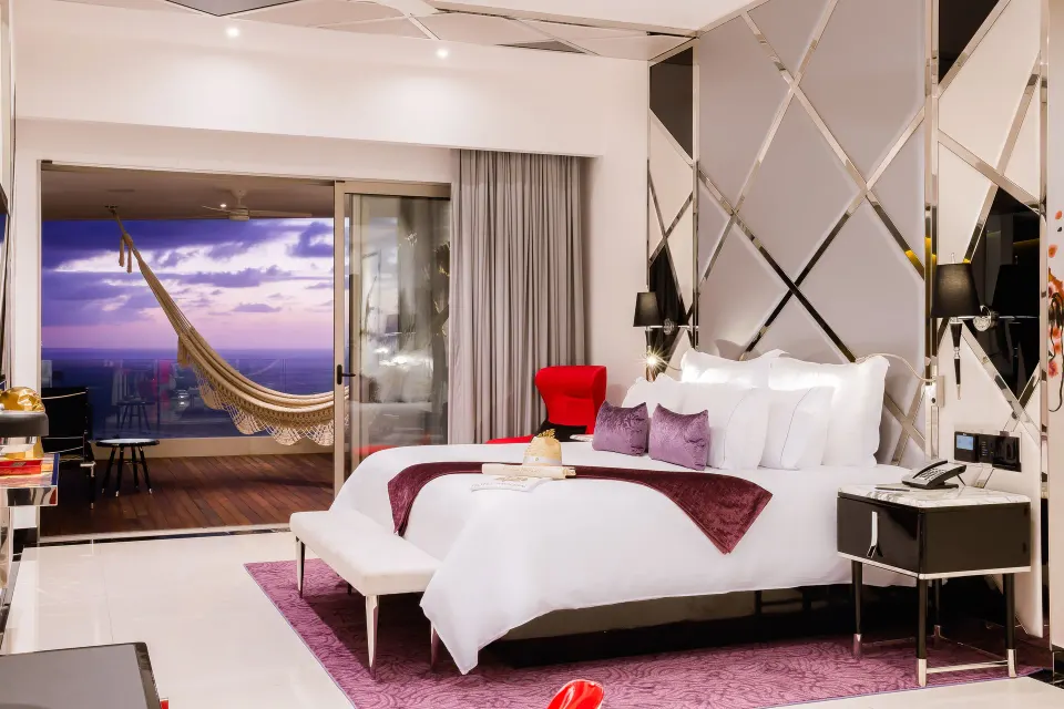 Ultra room king bed with balcony hammock and ocean view at Hotel Mousai Puerto Vallarta.