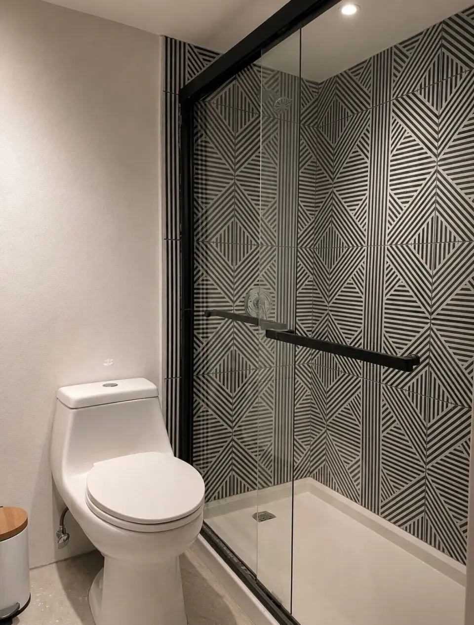 Deluxe room bathroom with glass shower and geometric tile at Hotel on the Cay.