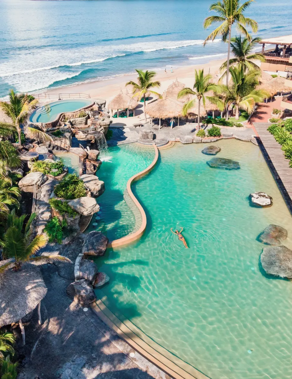 Aerial view of lagoon pools, palms and beach at Hotel Playa Mazatlan.